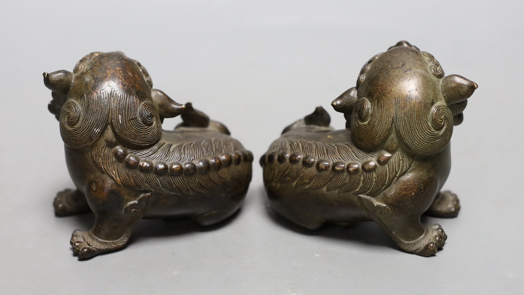 A pair of 18th/19th century Chinese or Japanese bronze lion-dog figures, 8cms high